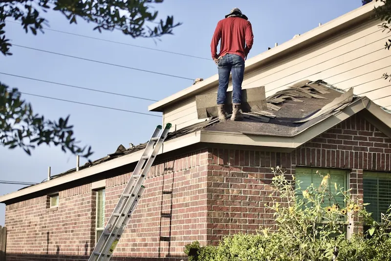 Professional roofer working on a residential roof in East Bay Park